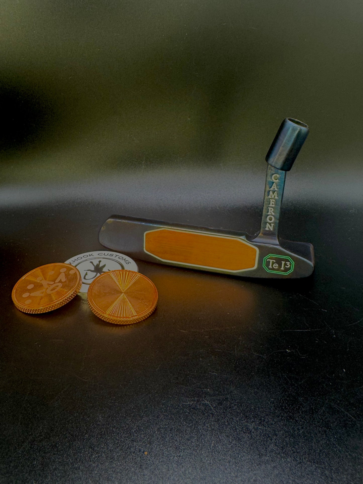 Putter with copper insert and iridescent body and matching ball marker