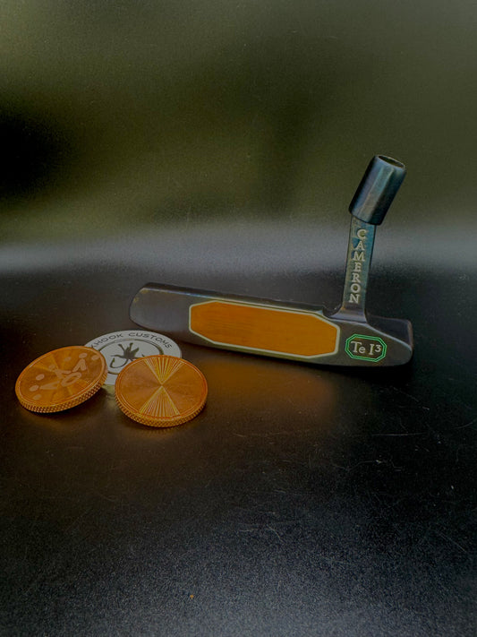 Putter with copper insert and iridescent body and matching ball marker